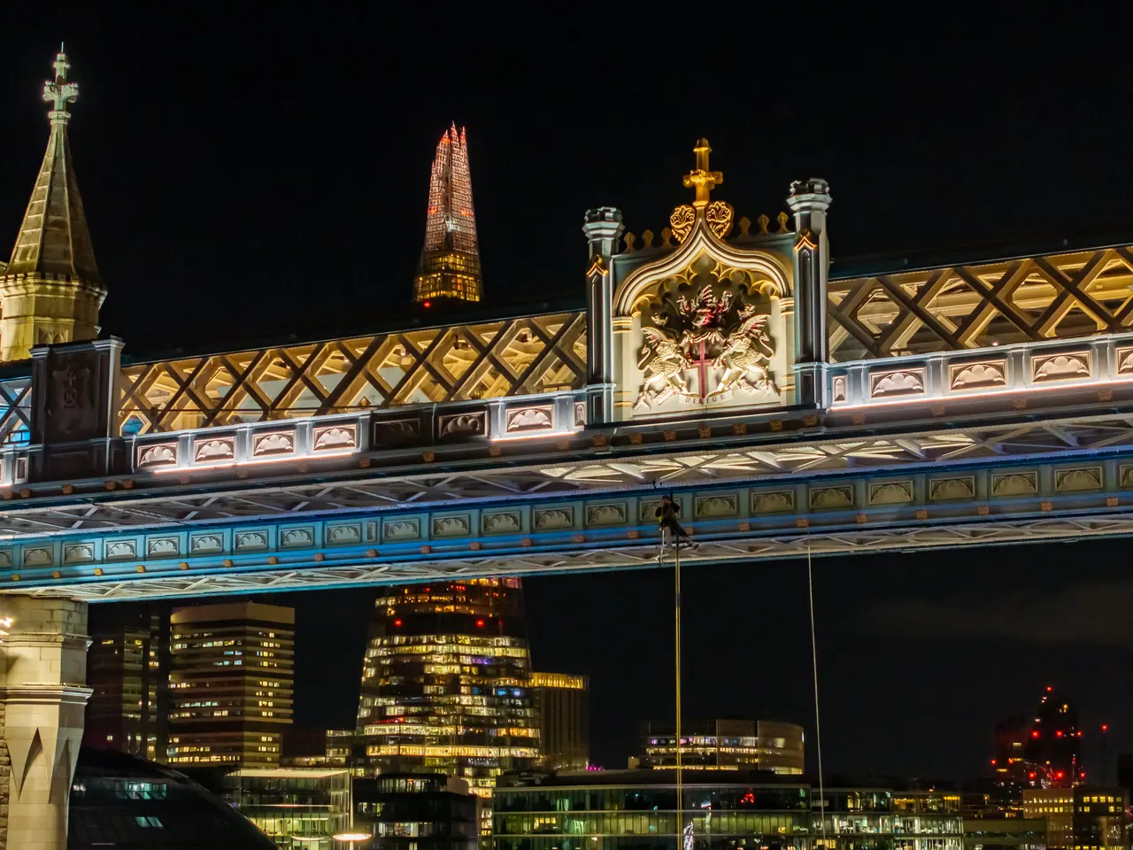 A closer view of the rope-access work at Tower Bridge at night