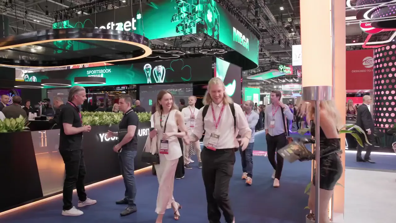 Visitors moving through a busy exhibition at ExCeL London