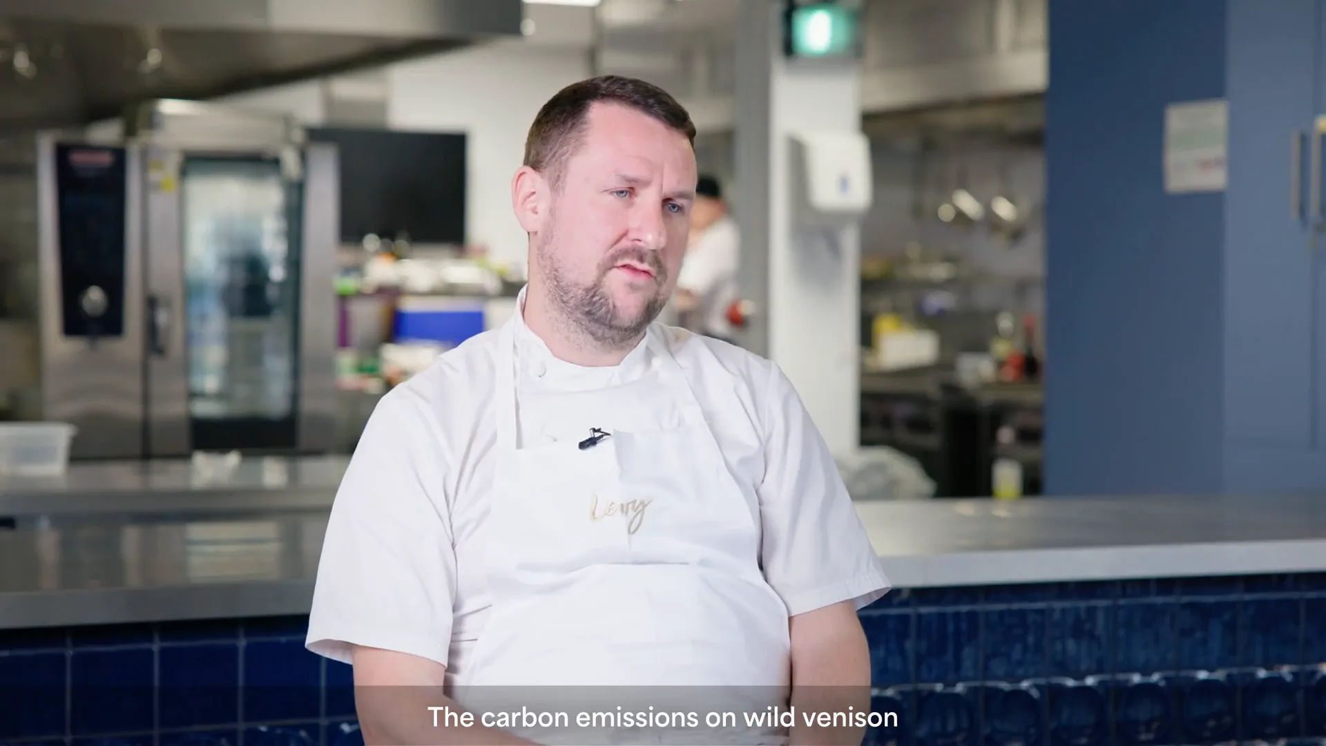 A chef speaking in the Game On competition kitchen
