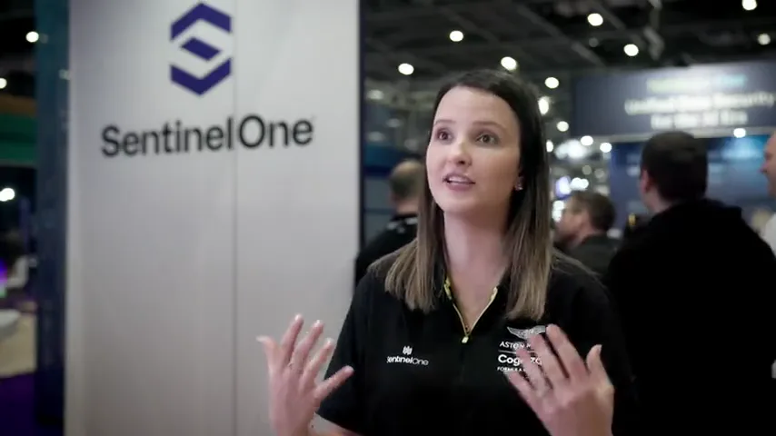 A contributor speaking beside SentinelOne event branding
