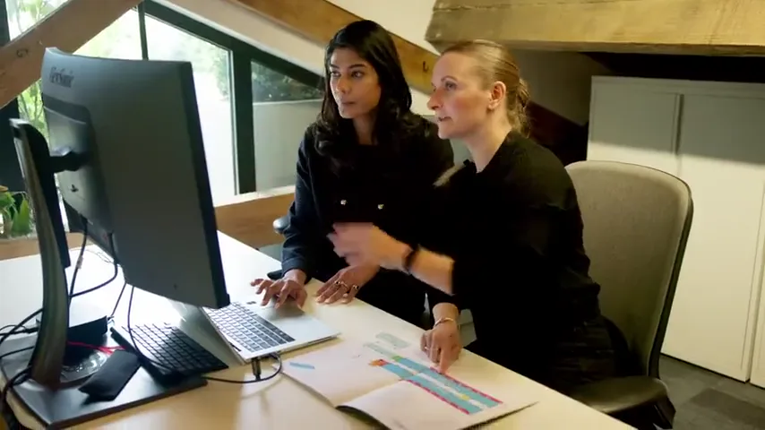 Two venue team members working at a screen
