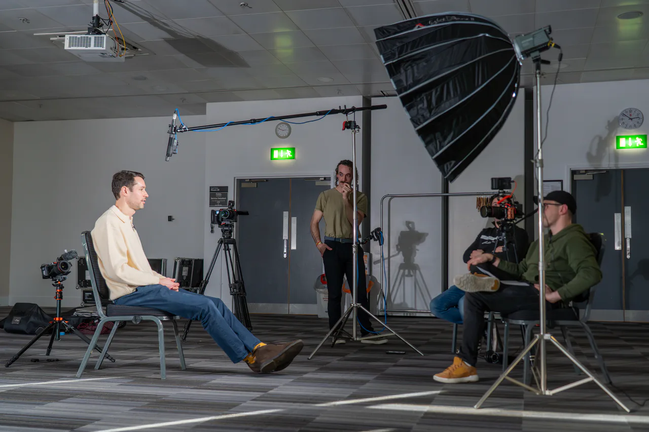 Airframe Media crew filming an interview with cinema cameras, studio lighting and a boom microphone