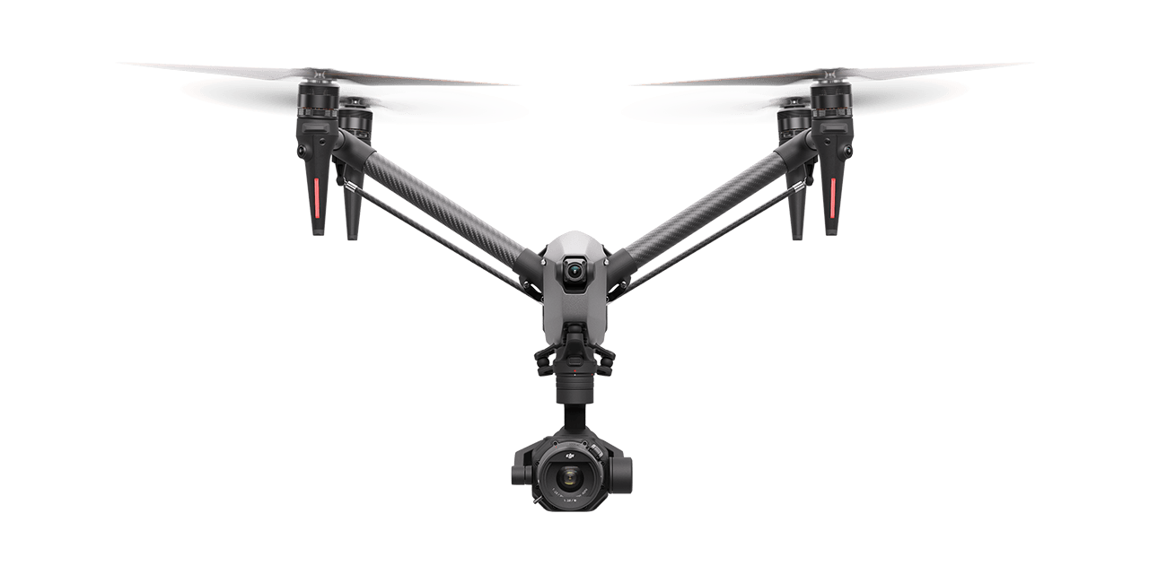 DJI Inspire 3 drone in flight against a clear sky, showcasing compact design.