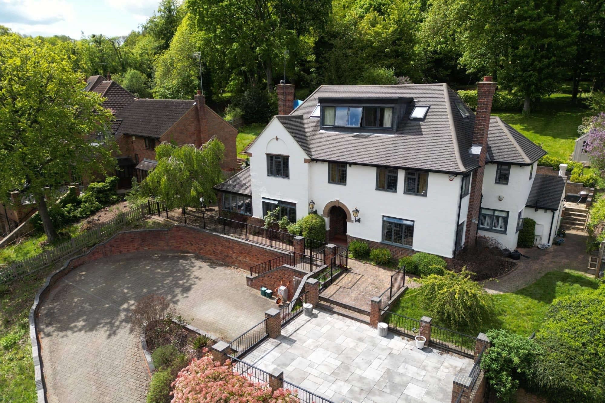 Aerial view of modern house with lush green garden in Hertfordshire
